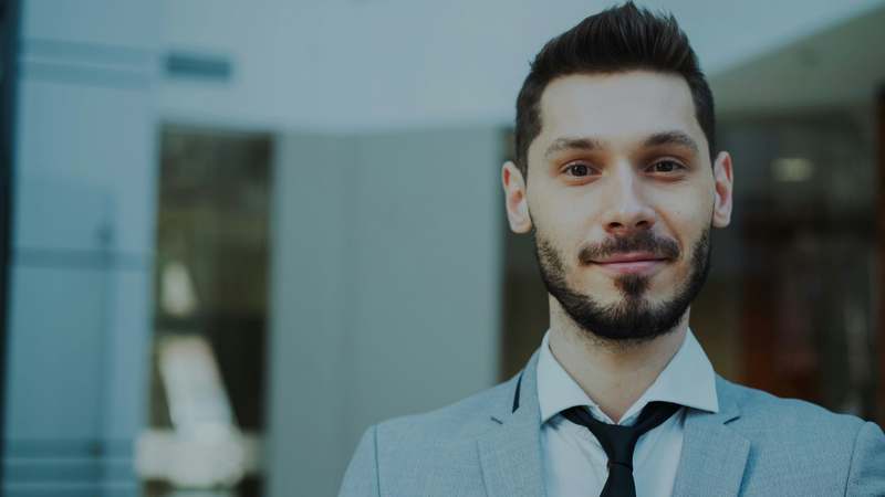 Finance professional confidently presenting to client in modern office setting